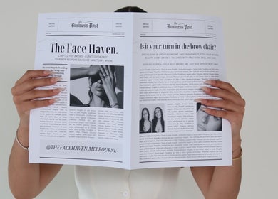 Person holding a newspaper showcasing The Face Haven in Melbourne, Victoria, AU.