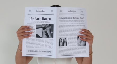 Hands holding newspaper ad for The Face Haven in Melbourne, Victoria, AU, showcasing beauty services.