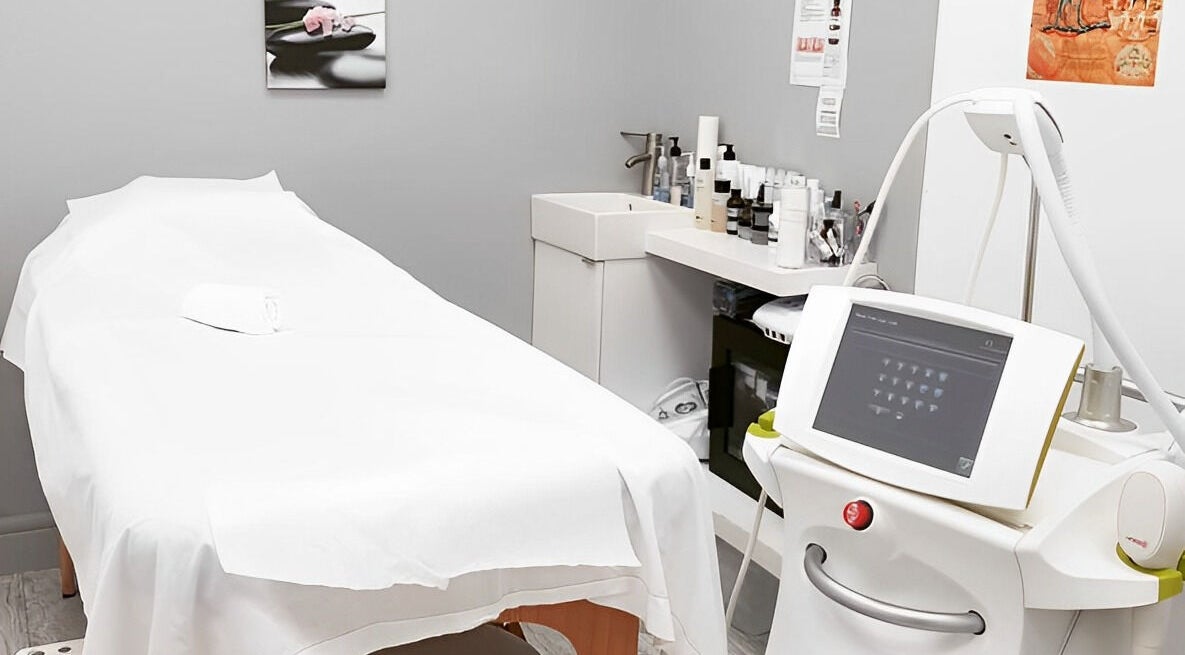Modern treatment room at The Laser Boutique in St. Catharines, Ontario, CA, showcasing professional laser equipment.