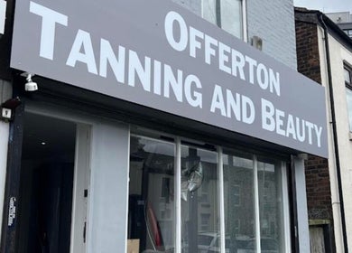 Front view of Offerton Tanning & Beauty in Stockport, England, GB, showcasing its sleek storefront design.
