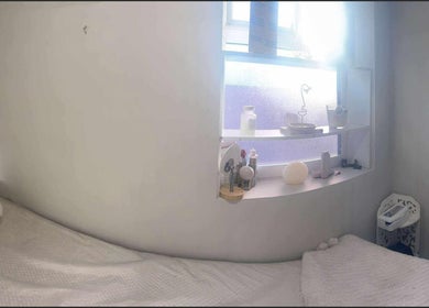 Relaxing treatment room at Offerton Tanning & Beauty, Stockport, England, GB, with cozy bed and calming decor.