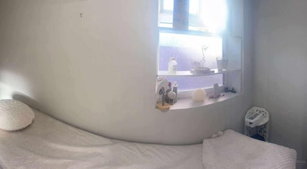 Relaxing treatment room at Offerton Tanning & Beauty, Stockport, England, GB, with cozy bed and calming decor.