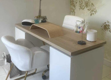 Elegant nail station at Offerton Tanning & Beauty, Stockport, England, GB with chic white chairs and a wooden desk.