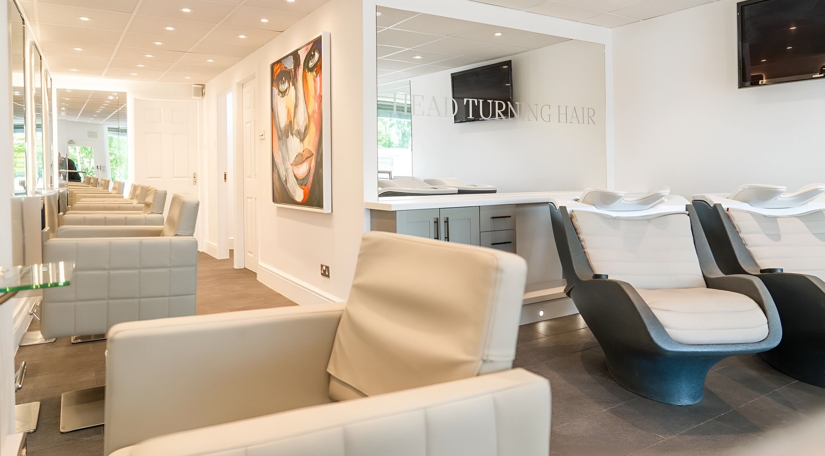 Modern salon interior at Salon 32, Middlewich, England, GB, showcasing stylish seating and an elegant design.