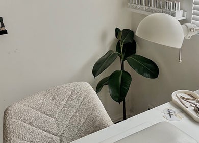 Hayley Lauren Makeup & Beauty serene workspace in Featherstone, England, GB with tools and lush plant.