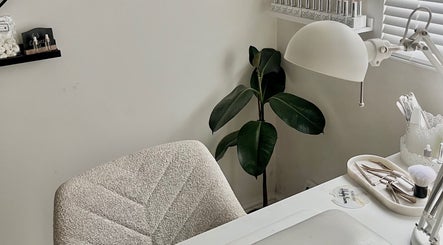 Hayley Lauren Makeup & Beauty serene workspace in Featherstone, England, GB with tools and lush plant.