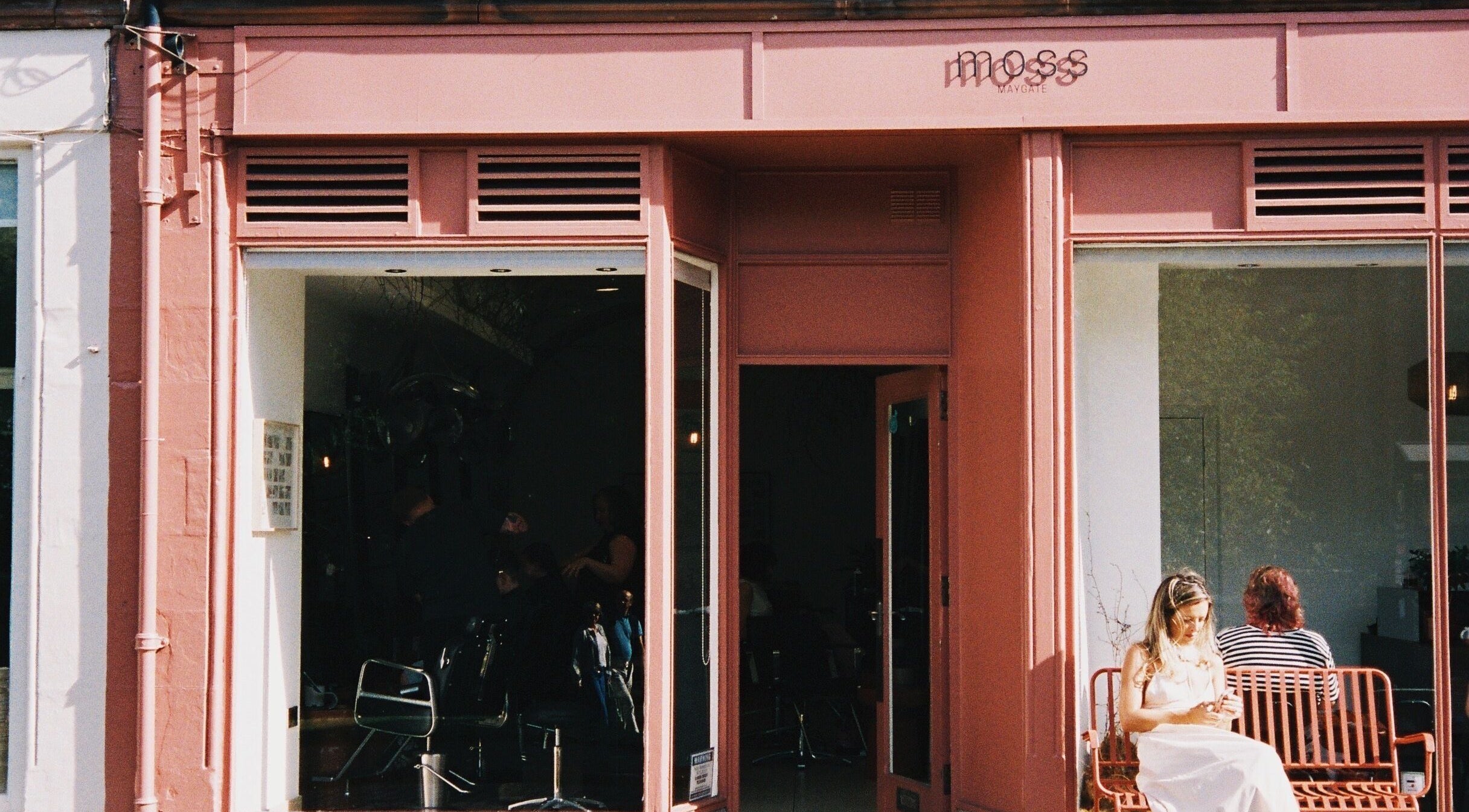 Moss Hairdressing's stylish pink facade in Dunfermline, Scotland - a beauty and wellness haven. Call 01383 623918.