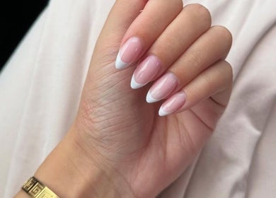 Elegant French manicure at Rhea Manicure, Manchester, England, GB showcasing stunning nail art design.