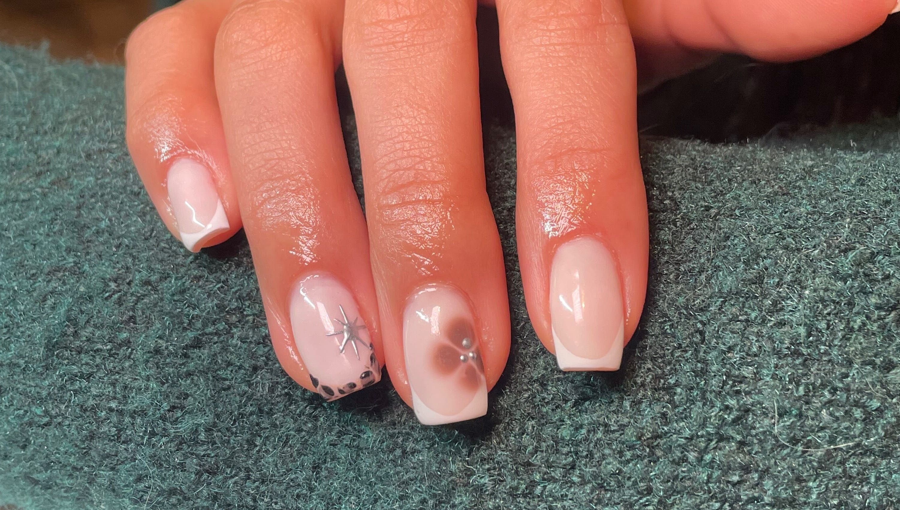 Beautiful nail art at Rhea Manicure, Manchester, England, GB showcasing intricate floral designs.