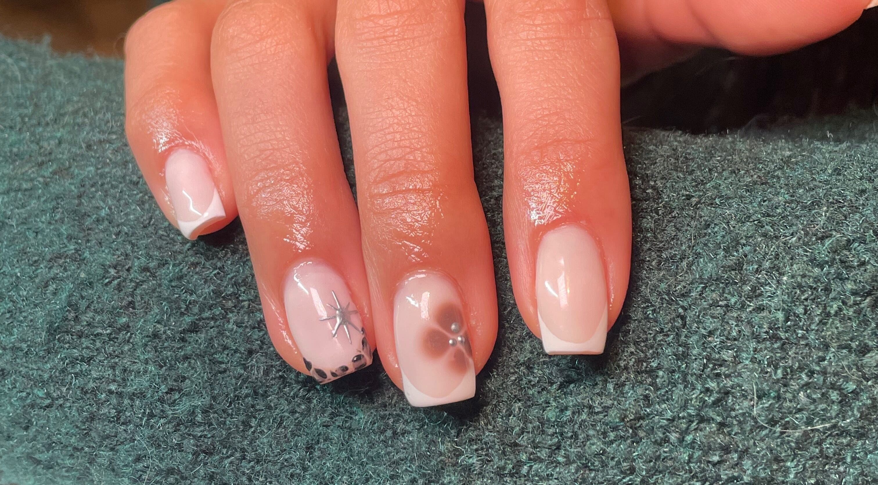 Beautiful nail art at Rhea Manicure, Manchester, England, GB showcasing intricate floral designs.