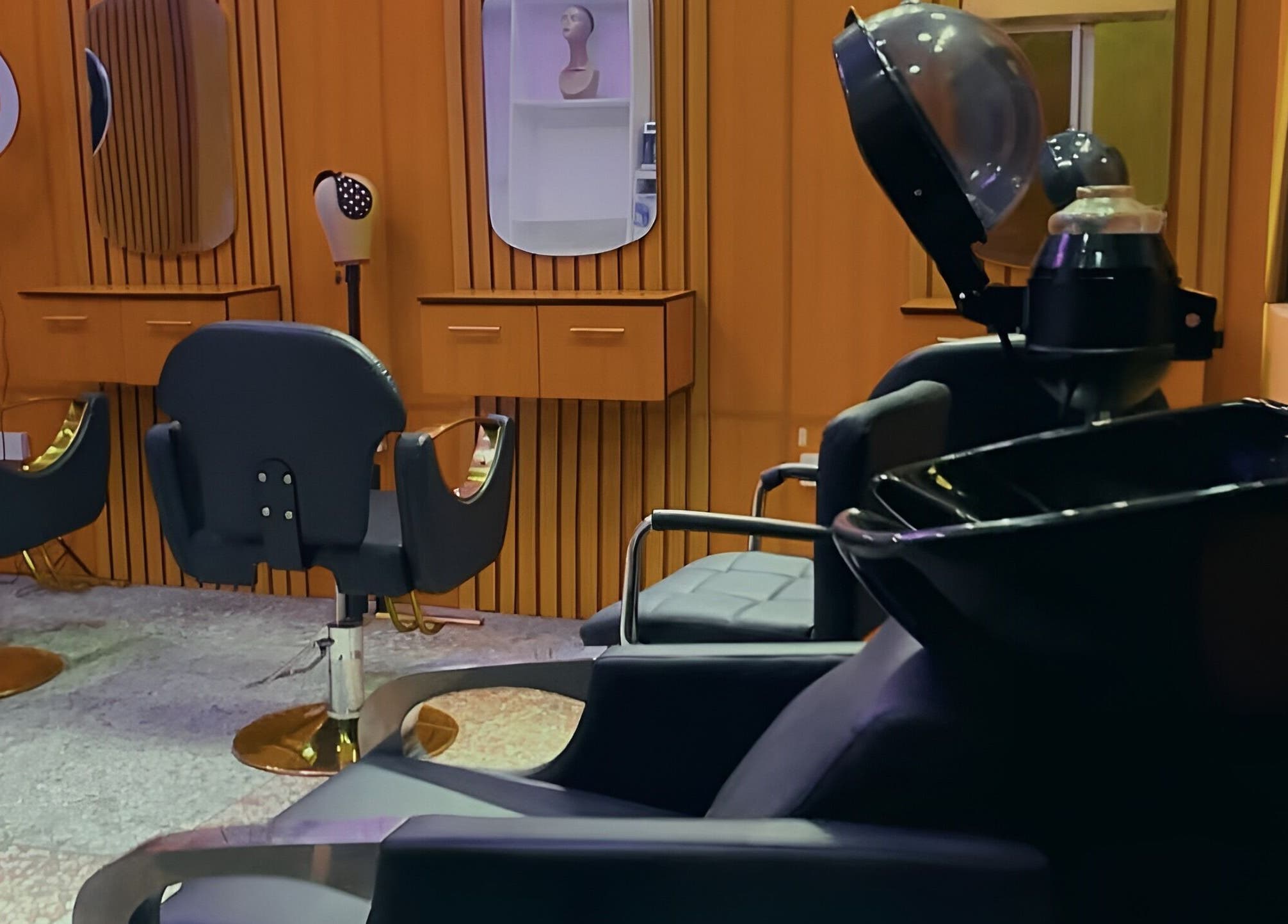 Stylish interior of KNG Beauty Bar in Lagos, Lagos, NG featuring modern salon chairs and drying stations.