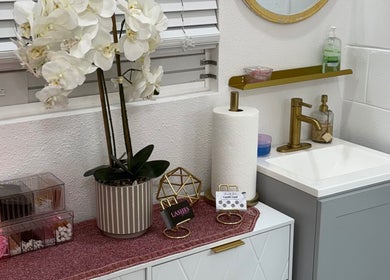 Chic interior of CuteTique Salon in Kissimmee, Florida, US with orchids and gold accents.