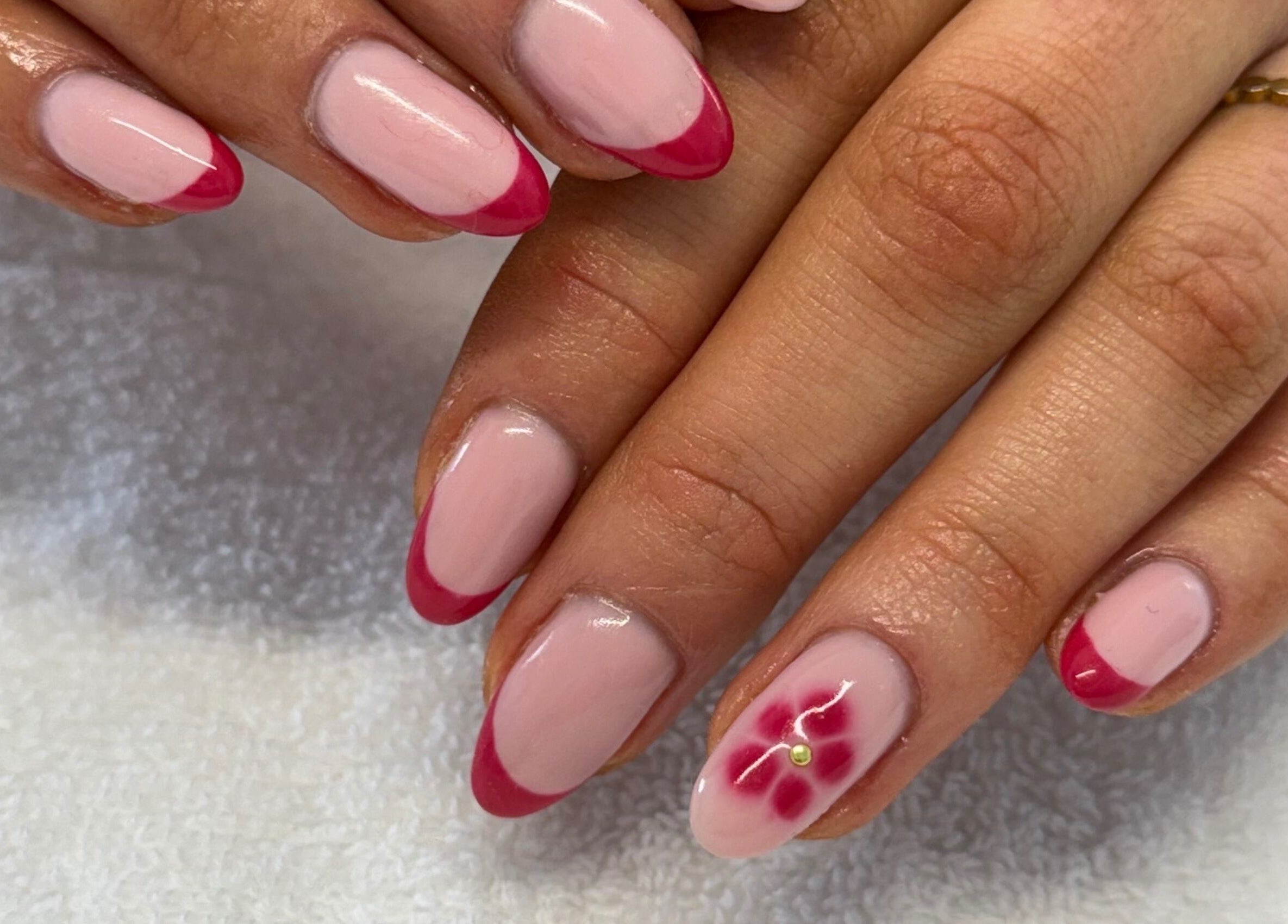 Elegant red-tipped nails with floral art at Creative Touch by RK in Tauranga, Bay of Plenty, NZ.