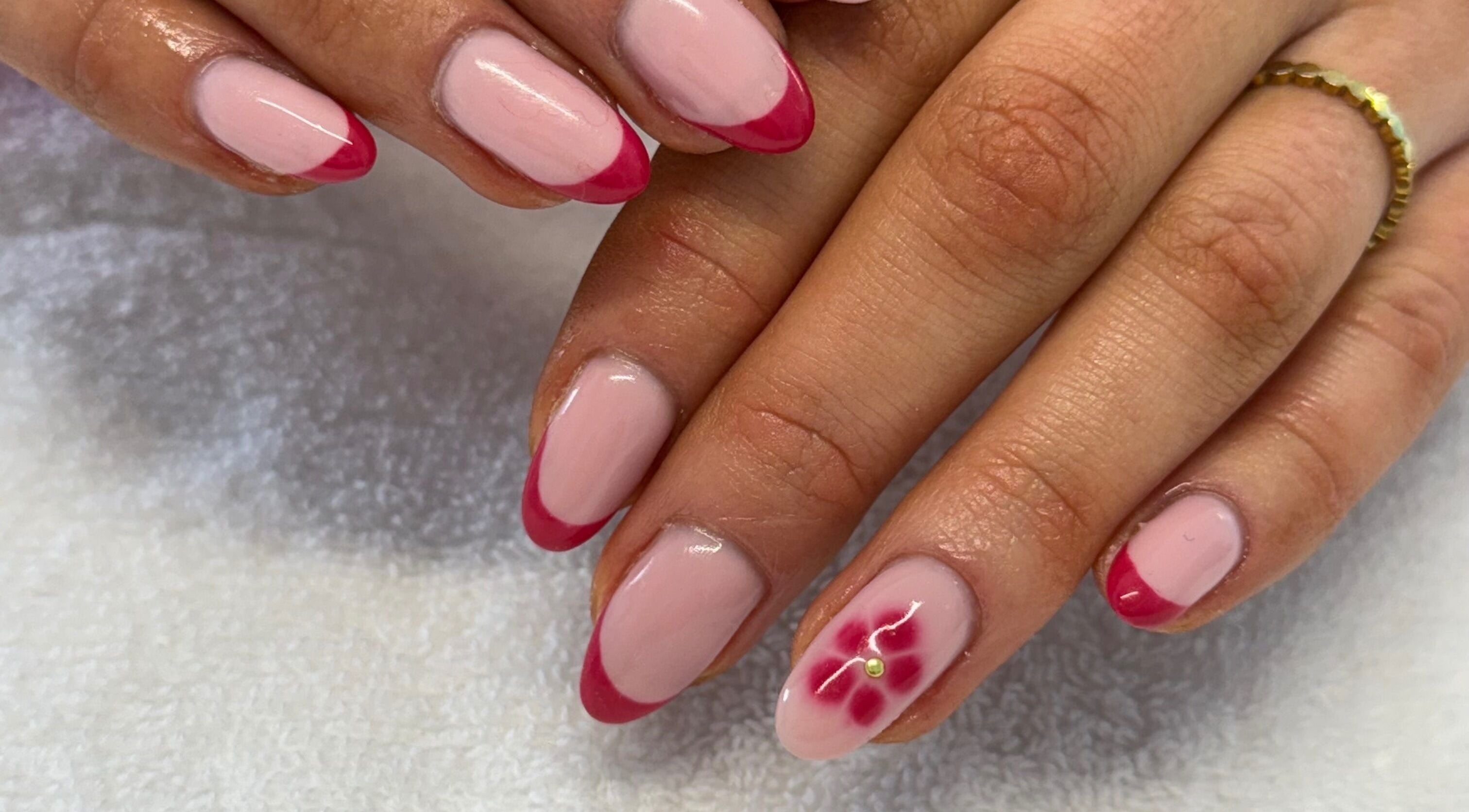 Elegant red-tipped nails with floral art at Creative Touch by RK in Tauranga, Bay of Plenty, NZ.