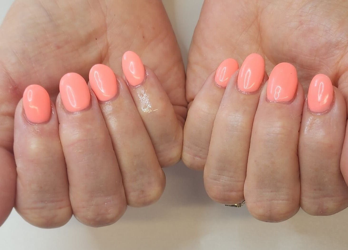 Vibrant coral manicured nails at Creative Touch by RK, Tauranga, Bay of Plenty, NZ, showcasing elegant nail art.