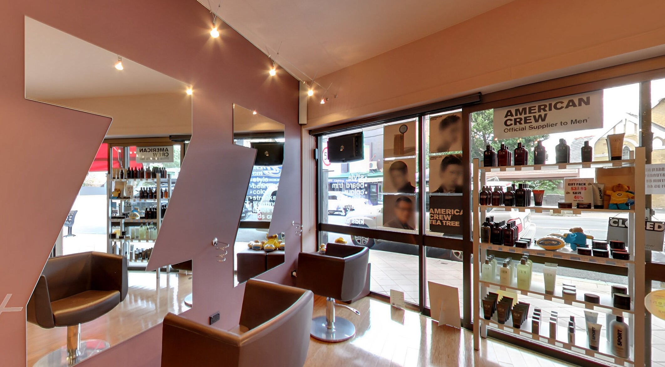Modern salon interior at Jazz Man Hair Gallery, Bondi Junction, New South Wales, AU with products and styling chairs.