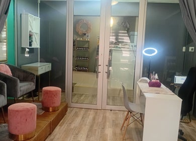 Modern beauty lounge at Betty's Touch Beauty, Pretoria, Gauteng, ZA with plush seating and nail care station.