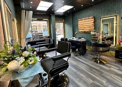 Modern interior of Somi’s Hair and Beauty in Glasgow, Scotland, GB, featuring stylish chairs and floral decor.