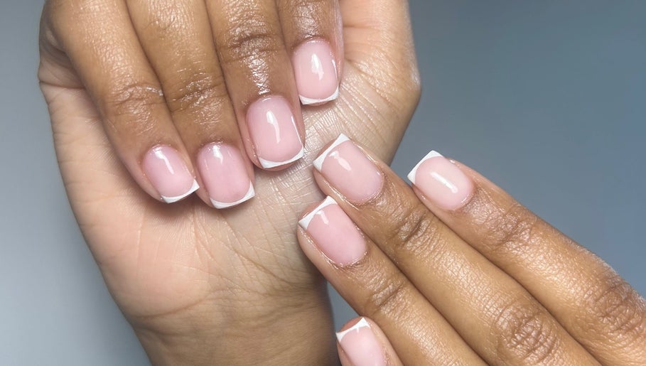 Elegant French manicure at Milan’s Vanity, Birmingham, England, GB, showcasing glossy, well-groomed nails.