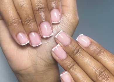 Elegant French manicure at Milan’s Vanity, Birmingham, England, GB, showcasing glossy, well-groomed nails.