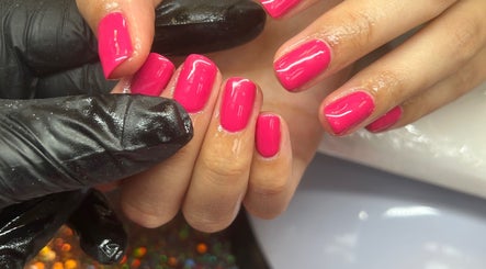Vibrant pink manicure at Milan’s Vanity, Birmingham, England, GB, showcasing expert nail care.