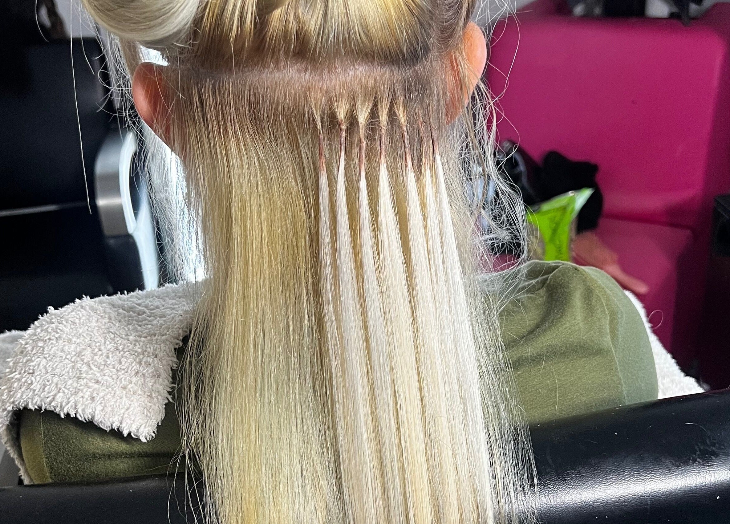 Hair extensions in progress at Glam Sanctuary, Stone Mountain, Georgia, US showcasing expert styling.