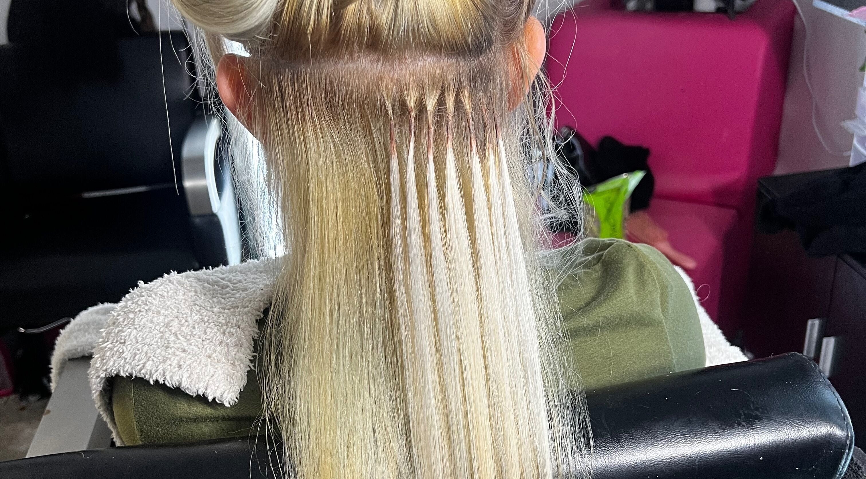 Hair extensions in progress at Glam Sanctuary, Stone Mountain, Georgia, US showcasing expert styling.