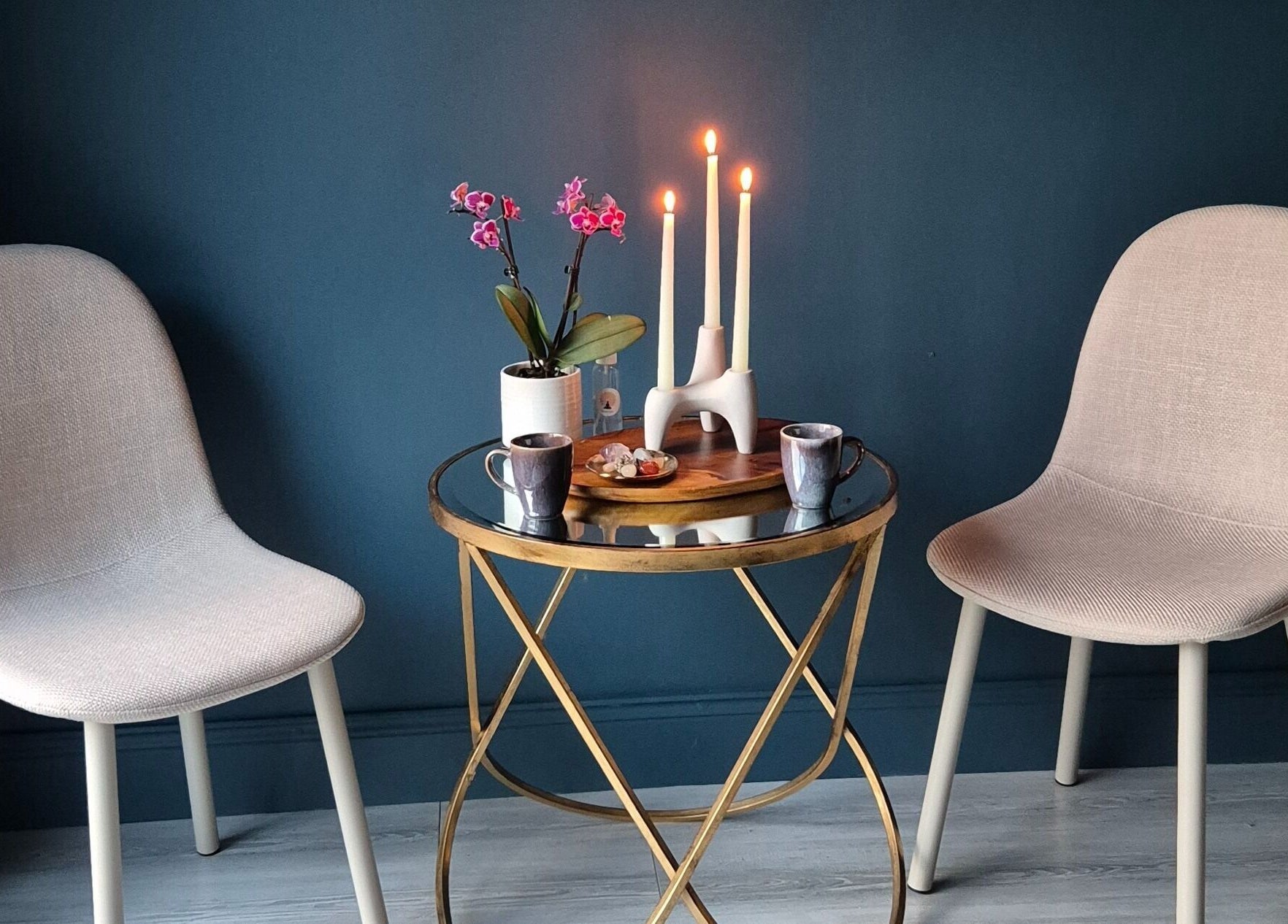 Elegant seating area at Riversview Reiki, Callan, County Kilkenny, IE with candles and a plant on a table.