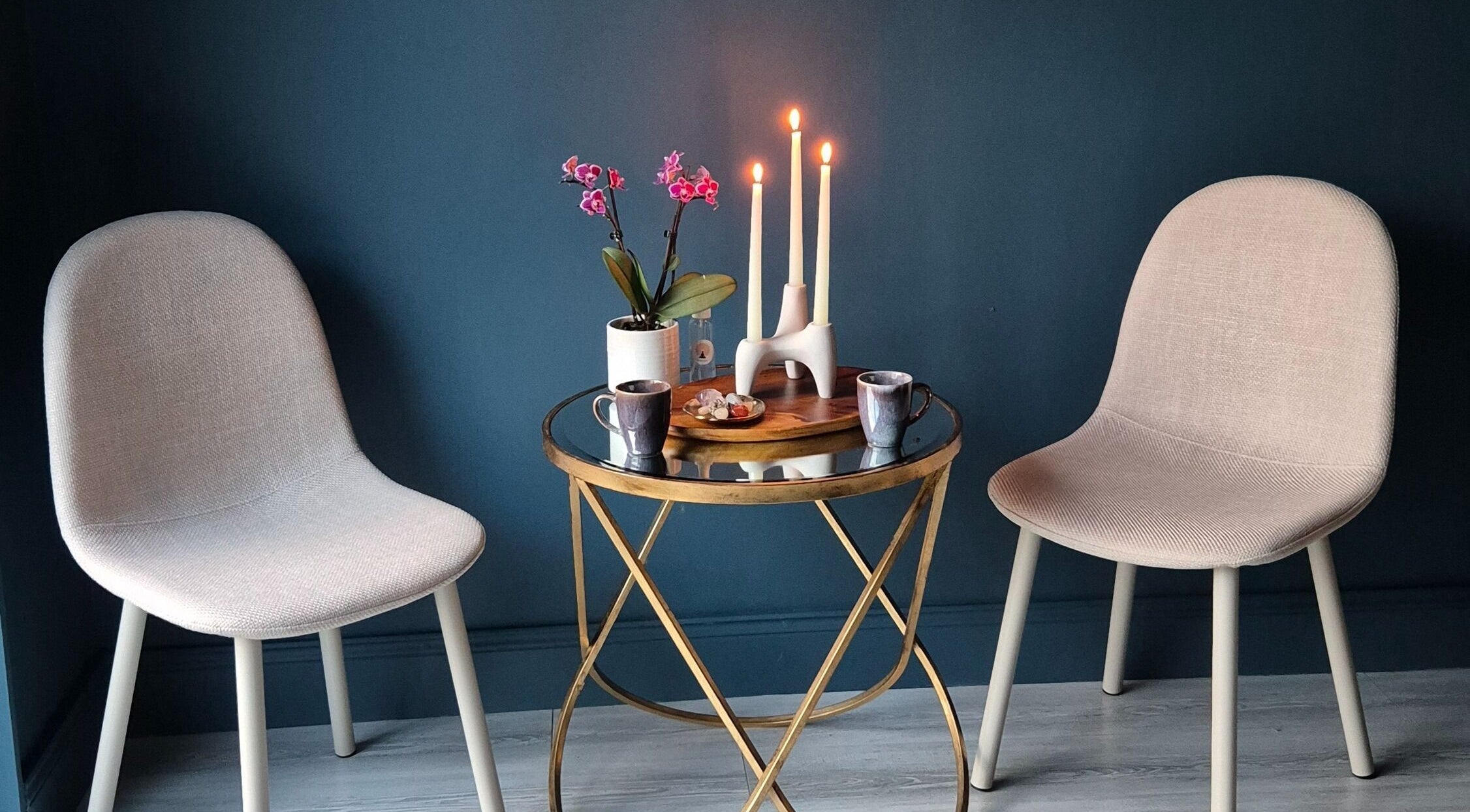 Elegant seating area at Riversview Reiki, Callan, County Kilkenny, IE with candles and a plant on a table.
