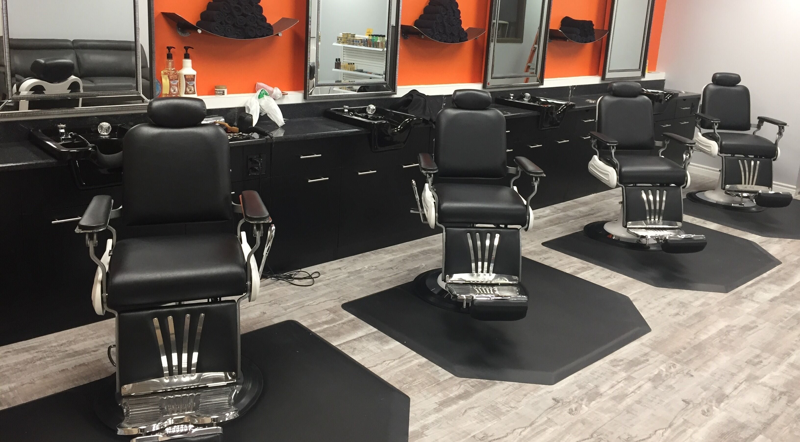 Modern barber chairs at Thumbs Up Barber Shop in Kitchener, Ontario, CA, ready for customers.