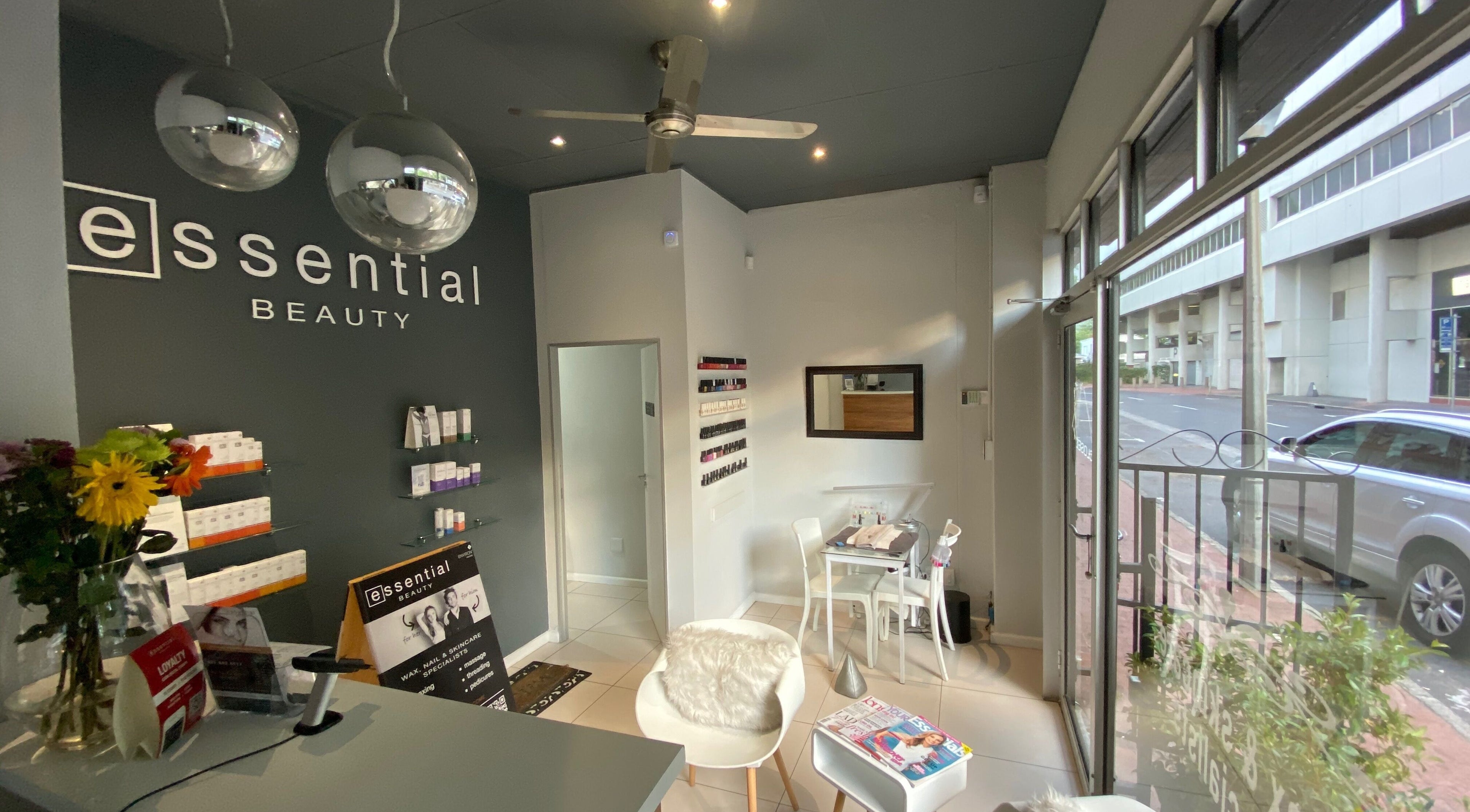 Stylish interior of Essential Beauty in Cape Town, Western Cape, ZA, showcasing modern design and cozy seating.