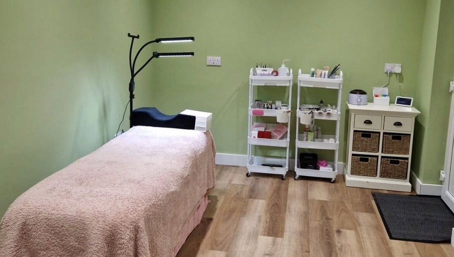 Tranquil treatment room at Cherry Tree Beauty, Yaxley, England, GB, featuring a cozy bed and beauty supplies.