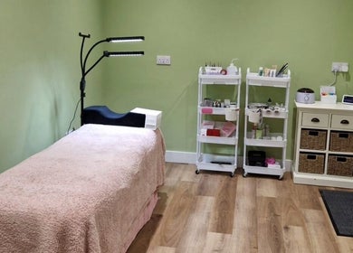 Tranquil treatment room at Cherry Tree Beauty, Yaxley, England, GB, featuring a cozy bed and beauty supplies.