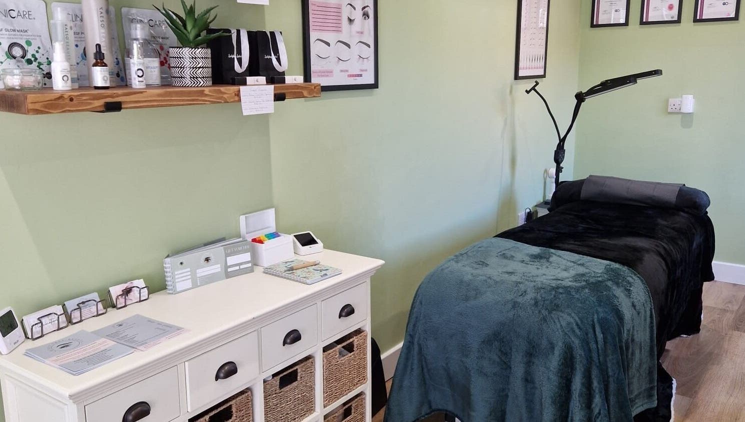 Tranquil spa room at Cherry Tree Beauty in Yaxley, England, GB with treatment bed and skincare products.