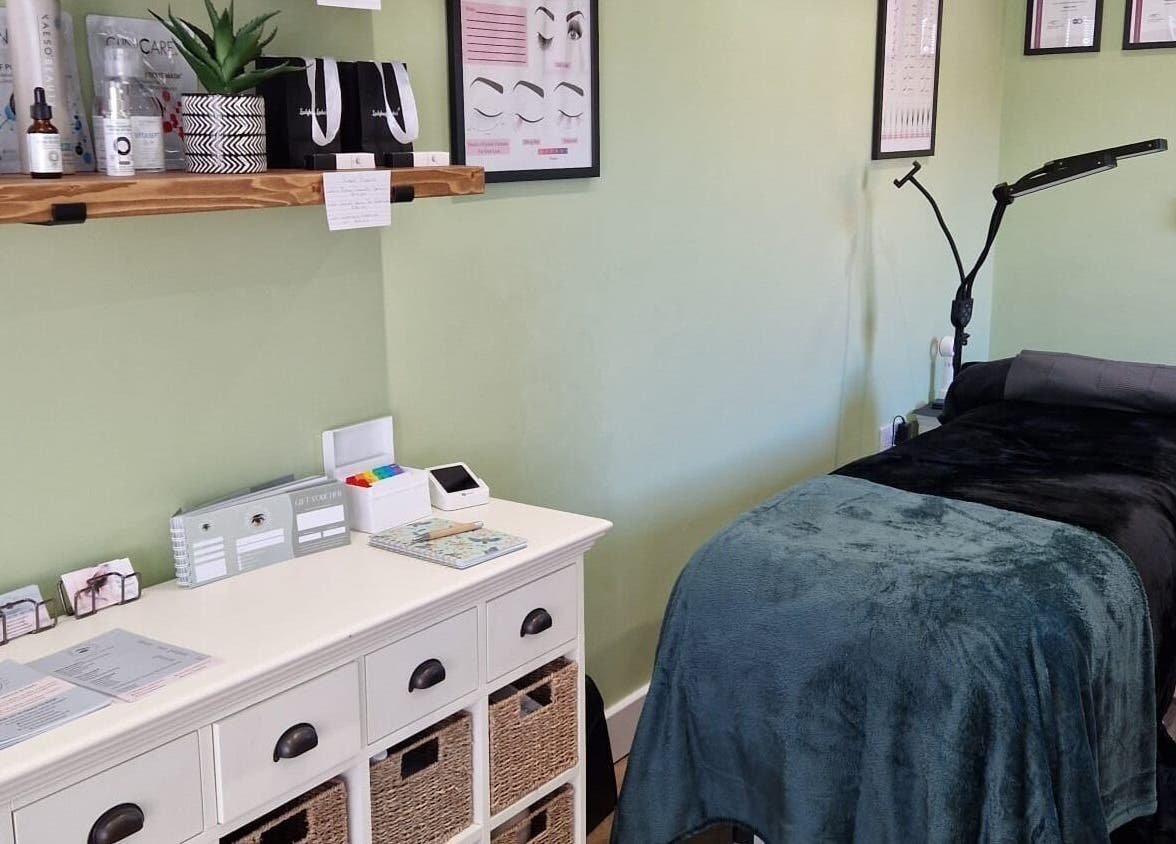 Tranquil spa room at Cherry Tree Beauty in Yaxley, England, GB with treatment bed and skincare products.