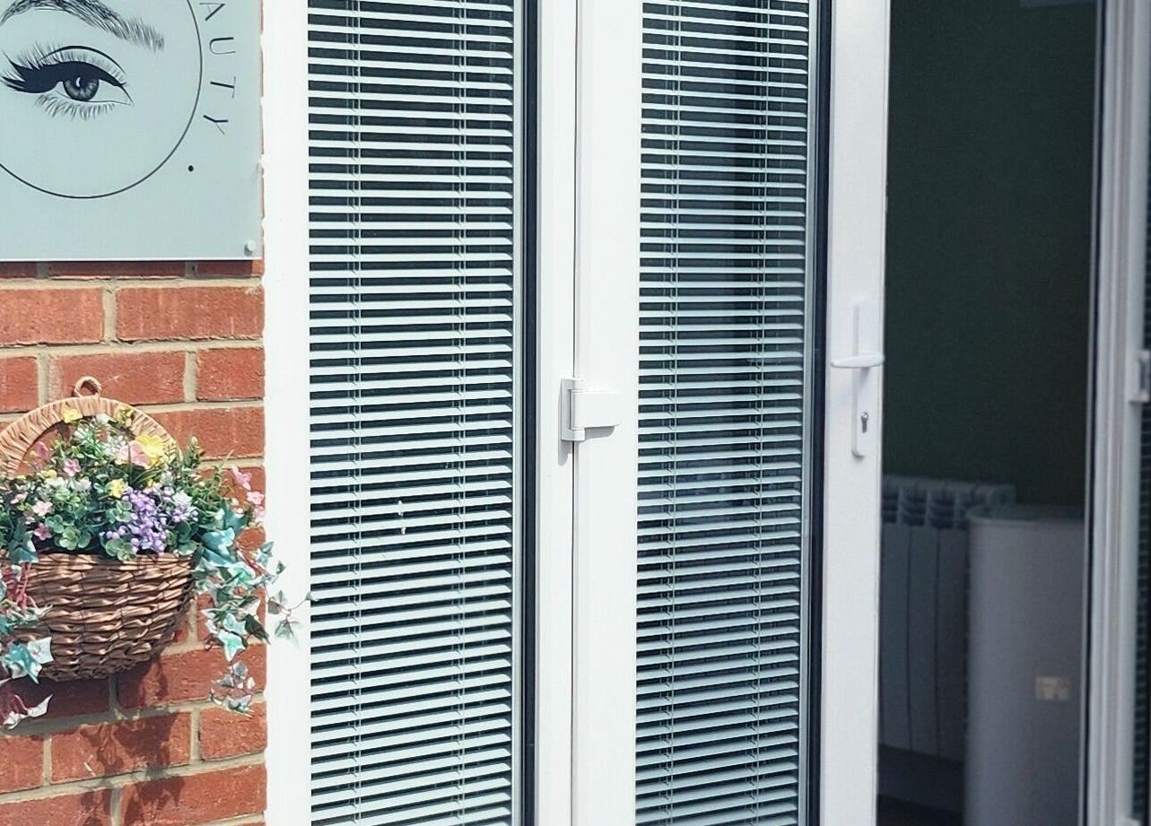 Entrance of Cherry Tree Beauty in Yaxley, England with a floral basket and brick wall.
