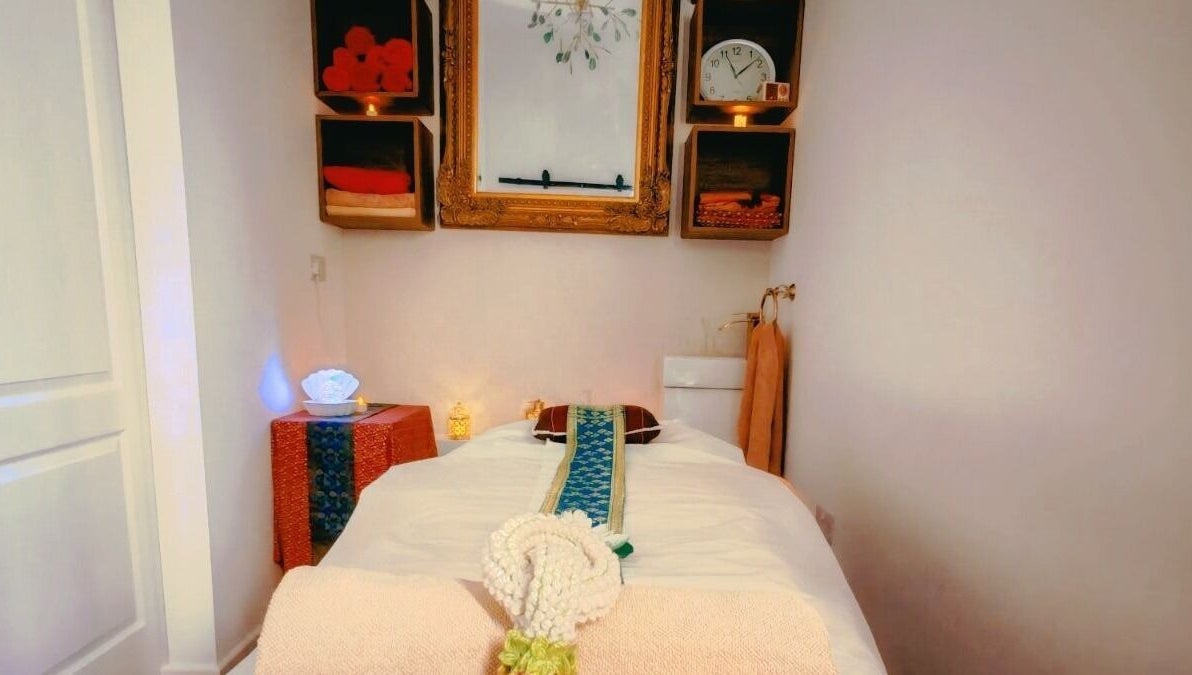 Relaxing massage room at The Andaman Sanctuary, Twickenham, England, GB, featuring warm lighting and a serene ambiance.