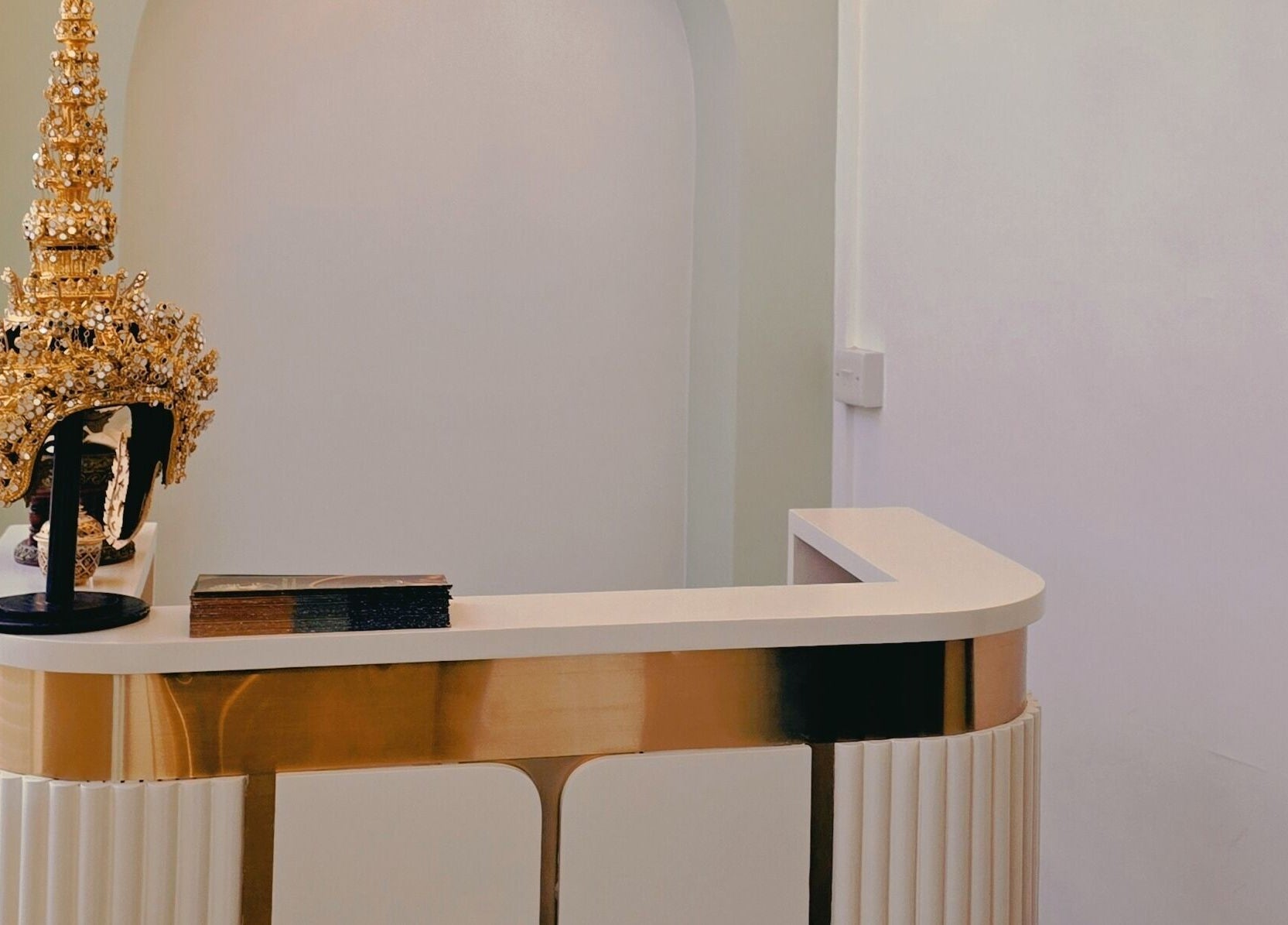 Elegant reception at The Andaman Sanctuary, Twickenham, England, with a golden decorative piece.