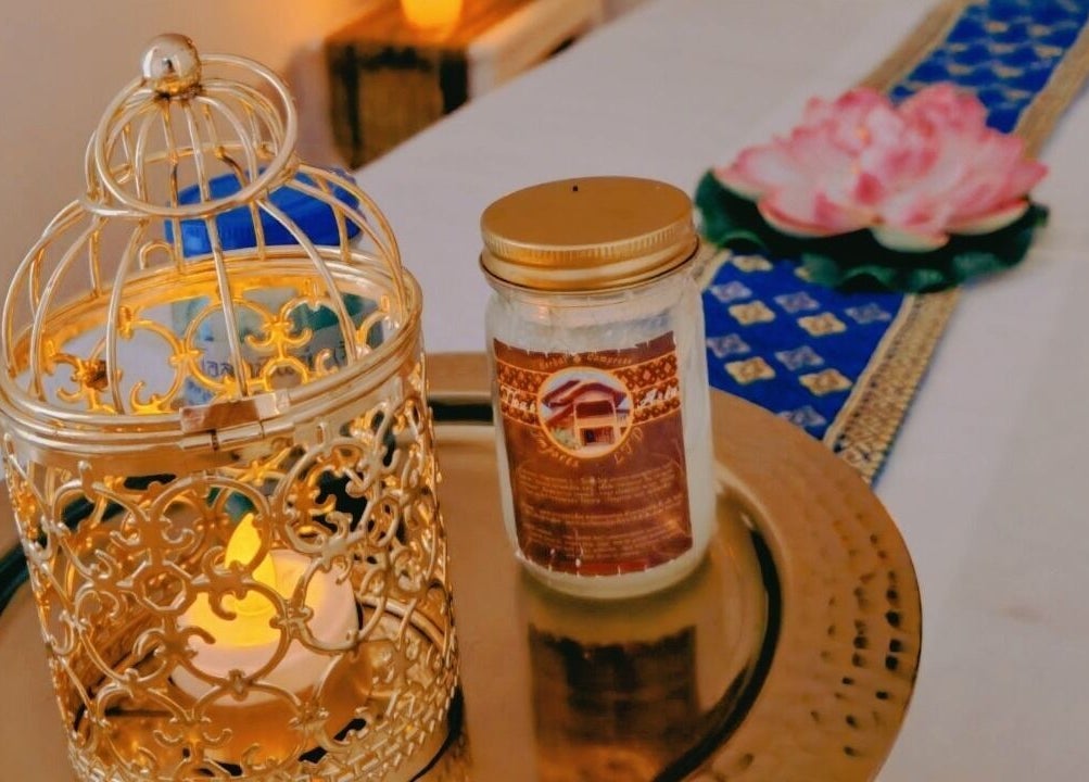 Elegant gold candle holder and lotus at The Andaman Sanctuary, Twickenham, England, GB.