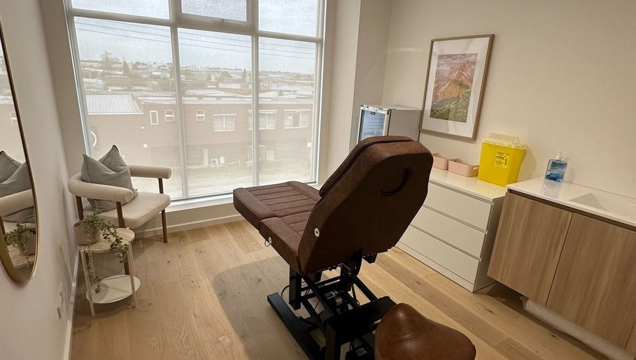 Elegant treatment room at Cosmetic Club, Melbourne, Victoria, AU with a plush chair and calming decor.