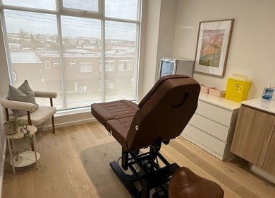 Elegant treatment room at Cosmetic Club, Melbourne, Victoria, AU with a plush chair and calming decor.