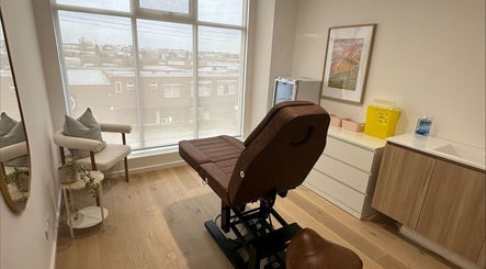 Elegant treatment room at Cosmetic Club, Melbourne, Victoria, AU with a plush chair and calming decor.