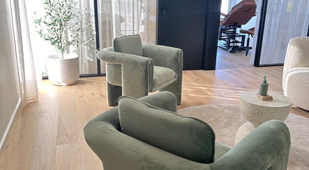 Serene lounge seating at Cosmetic Club, Melbourne, Victoria, AU featuring plush chairs and natural decor.