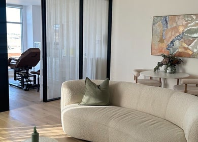 Elegant waiting area at Cosmetic Club, Melbourne, Victoria, AU with plush seating and modern decor.