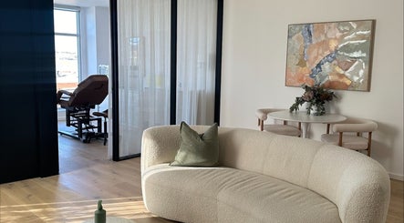 Elegant waiting area at Cosmetic Club, Melbourne, Victoria, AU with plush seating and modern decor.
