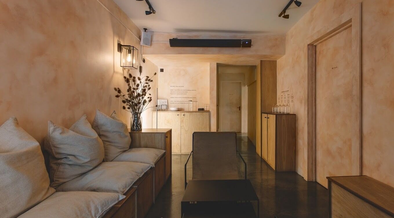 Relaxing seating area at MASAJ Shoreditch, London, England, GB with soft pillows and warm lighting.