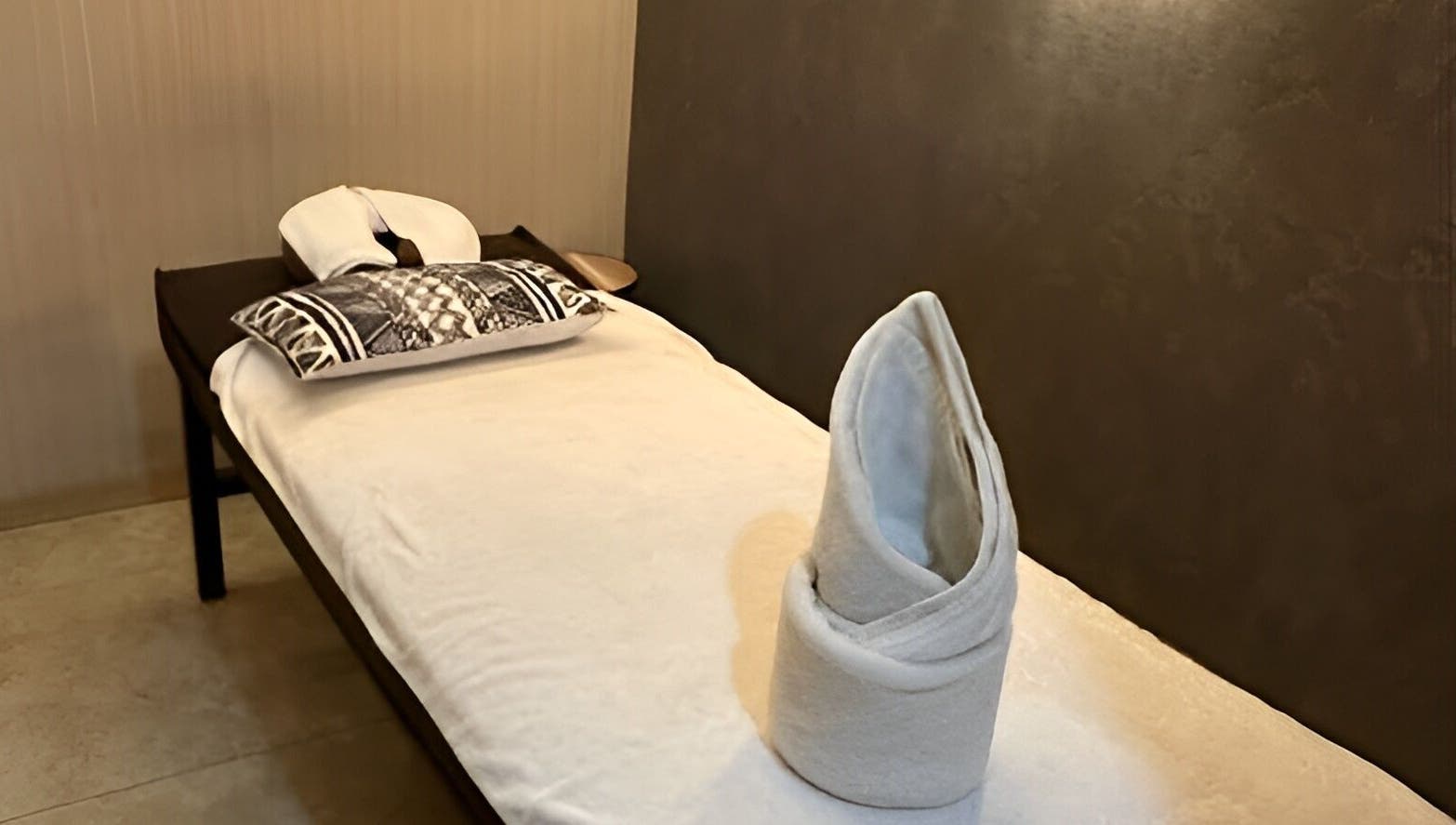 Peaceful massage bed setup at The FIRST Spa in Cebu City, Central Visayas, PH, with towel art.