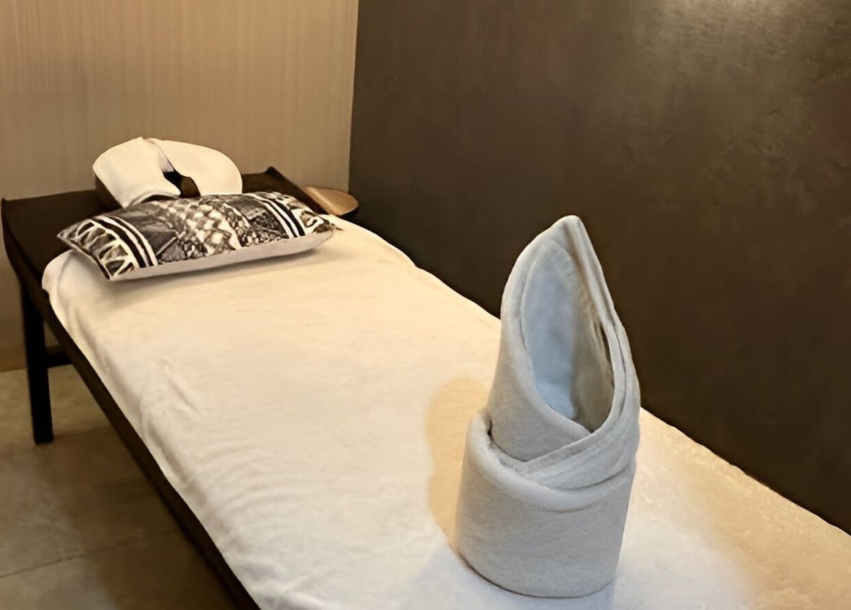 Peaceful massage bed setup at The FIRST Spa in Cebu City, Central Visayas, PH, with towel art.