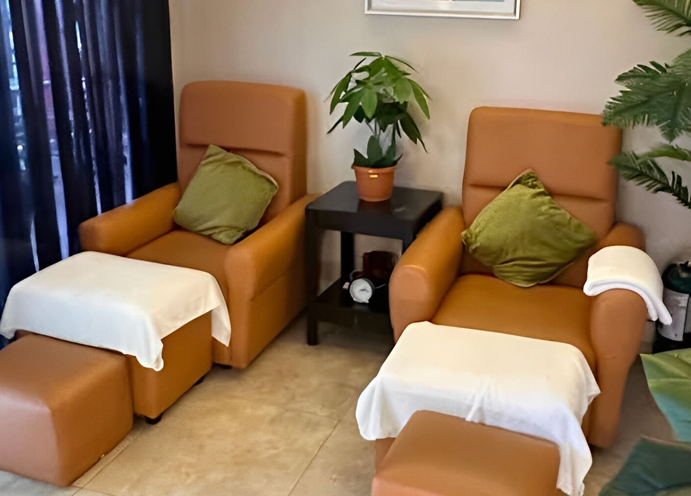 Cozy chairs at The FIRST Spa, Cebu City, Central Visayas, PH offer serene relaxation amid lush greenery.