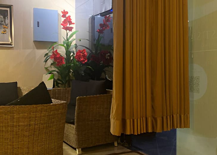 Relaxing seating area at The FIRST Spa, Cebu City, Central Visayas, PH with lush red flowers.